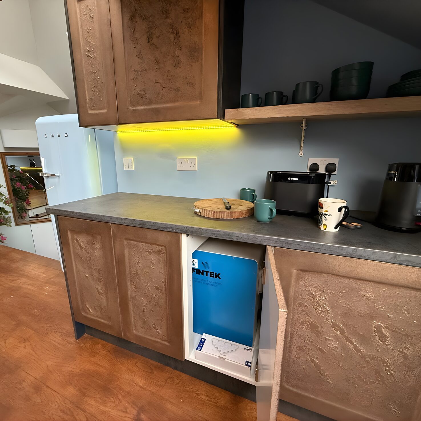 HomeKube Fintek unit installed inside kitchen cabinet — Kensington apartment